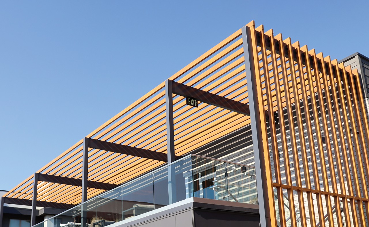 Wood vs. Aluminum Battens: The Specification Behind the Finish
