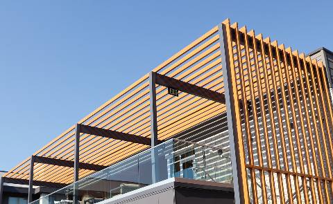 Wood vs. Aluminum Battens: The Specification Behind the Finish
